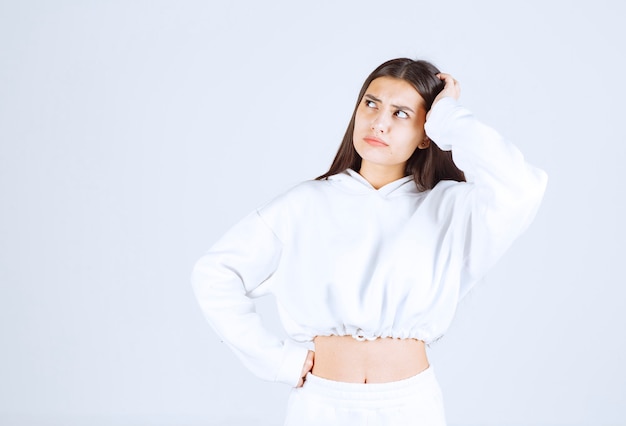 Portrait of girl model posing and posing on white-gray .