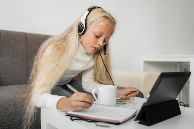 Free photo portrait of a girl paying attention to online class