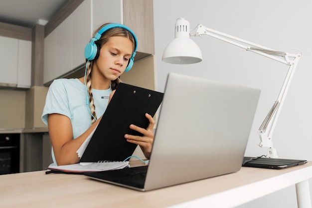 Free photo portrait of a girl paying attention to online class