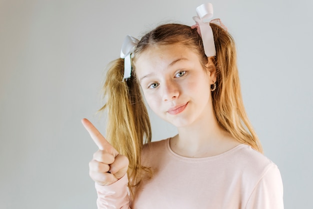 Portrait of a girl pointing upwards