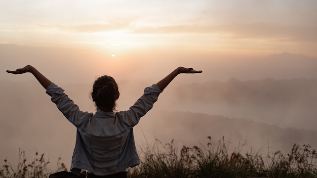 Portrait. girl pulls her hands to the sun. on the volcano batur. Bali Indonesia