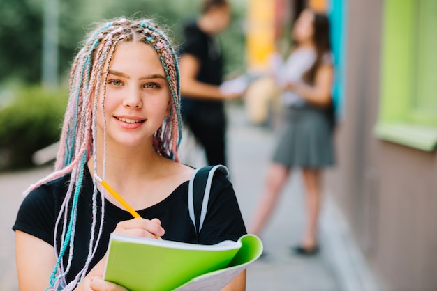 Free Photo portrait of girl with textbook