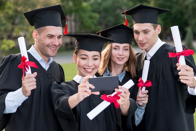 Portrait of group of students celebrating their graduation