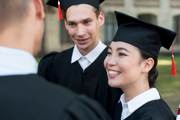 Free photo portrait of group of students celebrating their graduation