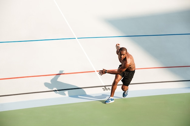 Portrait of a half naked healthy sportsman starting to run