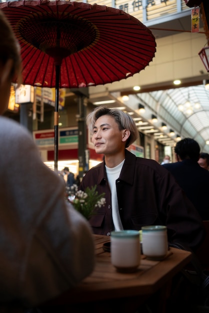 Free photo portrait of handsome asian man at a friends reunion