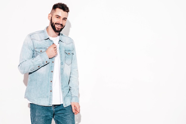 Portrait of handsome confident model Sexy stylish man Fashion hipster male posing near wall in studio Isolated