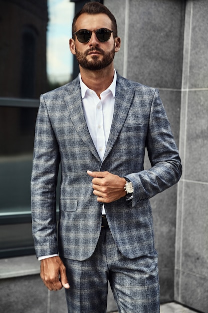 Free Photo portrait of handsome fashion businessman model dressed in elegant checkered suit