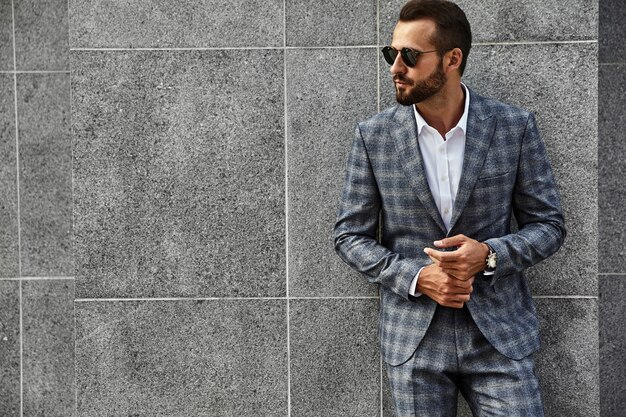 Free Photo portrait of handsome fashion businessman model dressed in elegant checkered suit