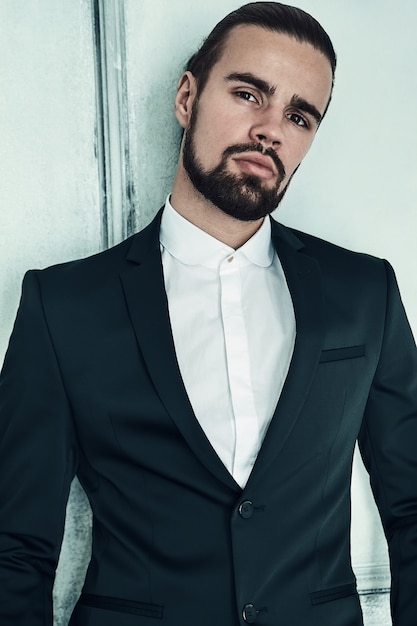 Free photo portrait of handsome fashion stylish hipster businessman model dressed in elegant black suit