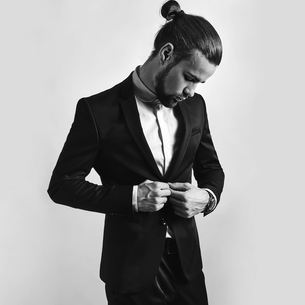 Free Photo portrait of handsome fashion stylish hipster businessman model dressed in elegant black suit.