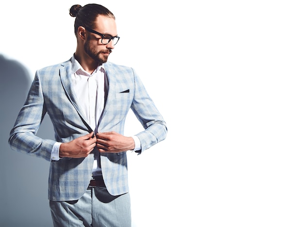 portrait of handsome fashion stylish hipster businessman model dressed in elegant light blue suit in glasses