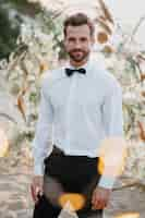 Free photo portrait of handsome groom at his beach wedding