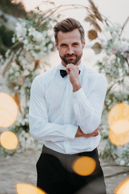 Portrait of handsome groom at his beach wedding