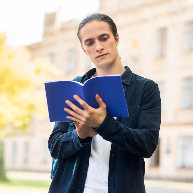 Portrait of handsome male studying at campus