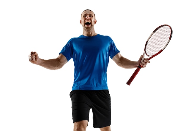 Portrait of a handsome male tennis player celebrating his success isolated on a white  wall. Human emotions, winner, sport, victory concept