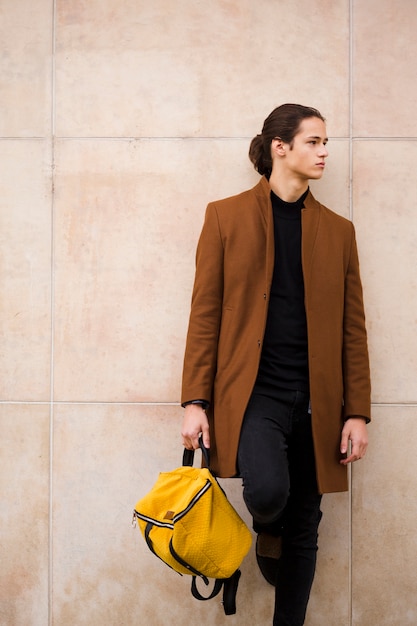 Portrait of handsome man holding a bag