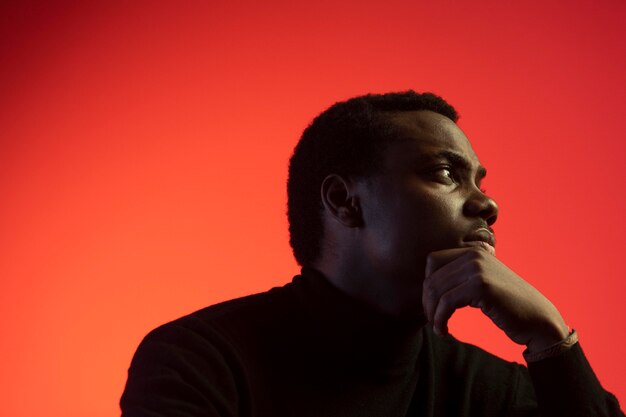 Portrait of handsome man over orange background