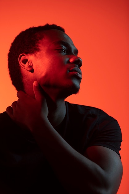 Portrait of handsome man over orange background