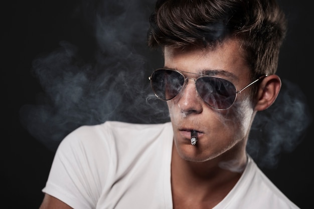 Portrait of handsome man with cigarette 
