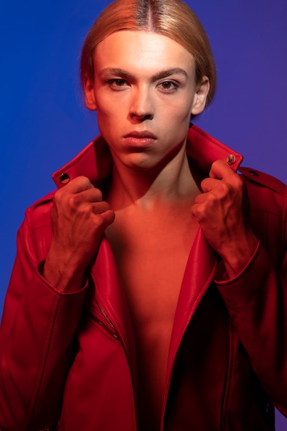 Portrait of handsome man with long blonde hair and red jacket