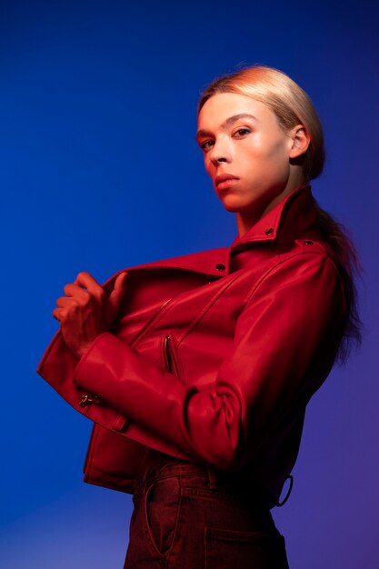 Portrait of handsome man with long blonde hair and red jacket