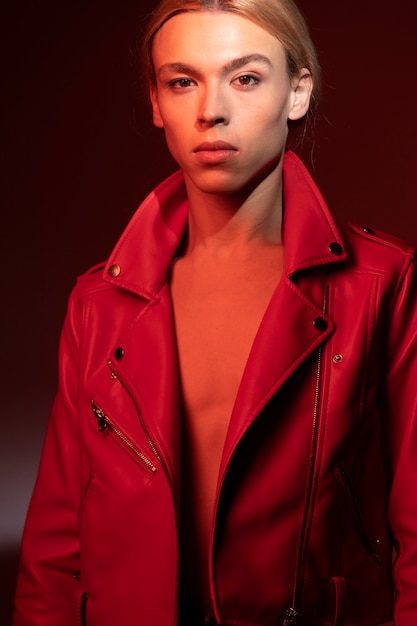 Free photo portrait of handsome man with long blonde hair wearing a red jacket