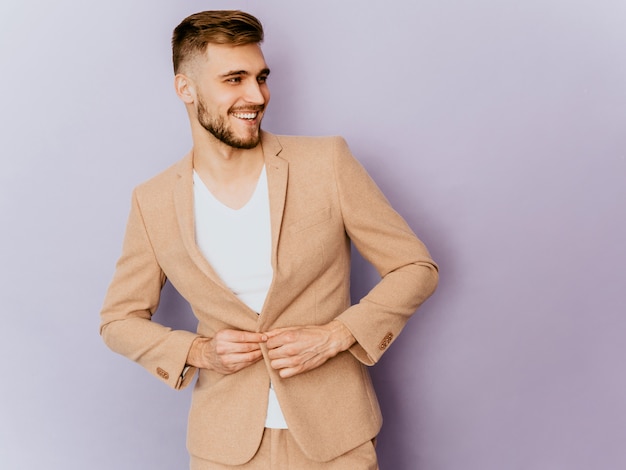 Free Photo portrait of handsome smiling hipster   businessman model wearing casual beige suit. 