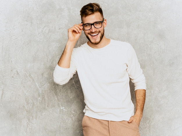 Portrait of handsome smiling hipster   businessman model wearing casual summer white clothes 