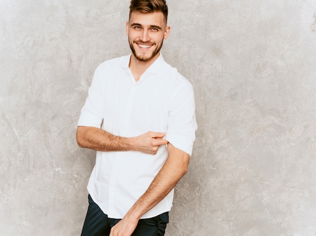 Free Photo portrait of handsome smiling hipster  businessman model wearing casual summer white shirt. 