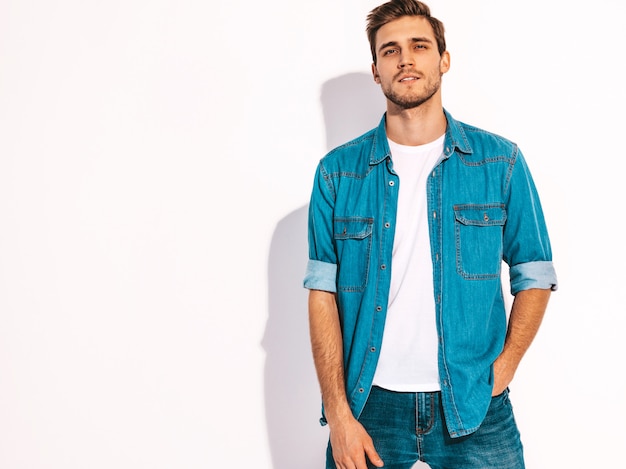 Portrait of handsome smiling stylish young man model dressed in jeans clothes. Fashion man 