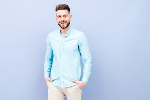 Portrait of handsome smiling young man wearing casual shirt and trousers