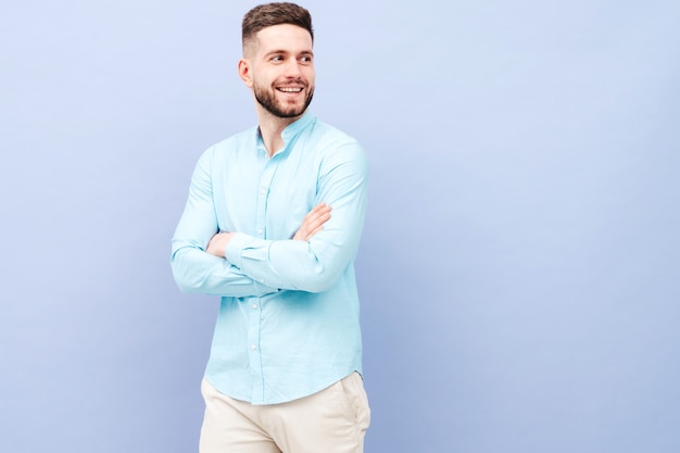 Portrait of handsome smiling young man wearing casual shirt and trousers