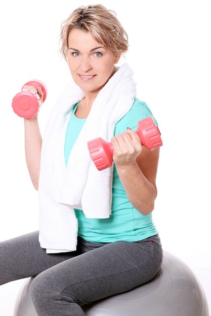 Portrait of happy aged sportswoman