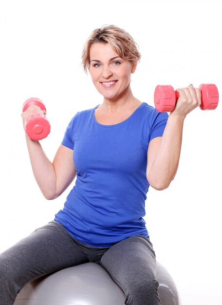 Portrait of happy aged sportswoman