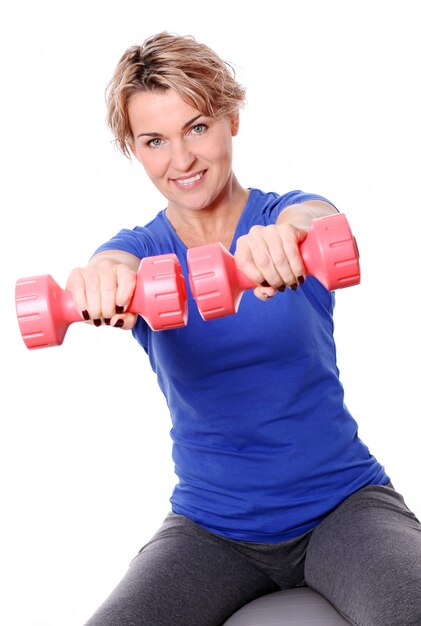 Portrait of happy aged sportswoman