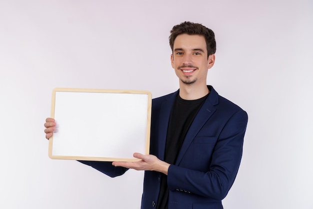 Free photo portrait of happy businessman showing blank signboard on isolated white background