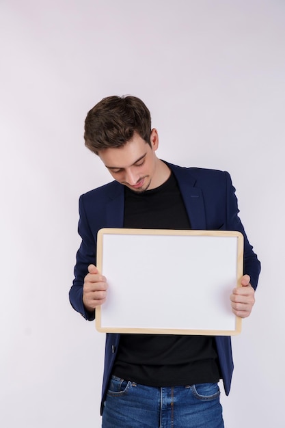 Free photo portrait of happy businessman showing blank signboard on isolated white background