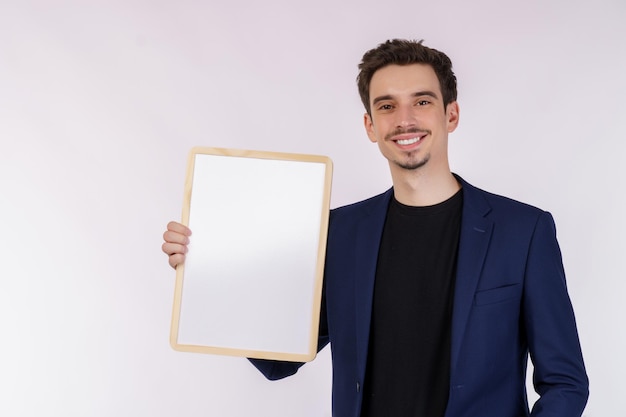 Free photo portrait of happy businessman showing blank signboard on isolated white background