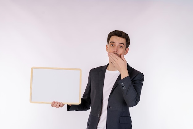 Free photo portrait of happy businessman showing blank signboard on isolated white background