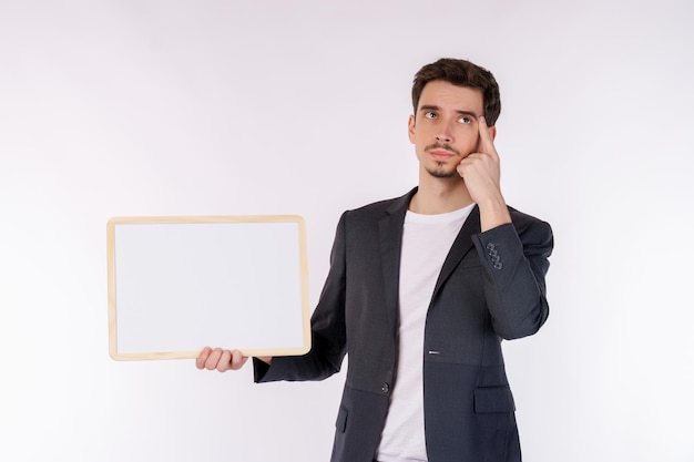 Free photo portrait of happy businessman showing blank signboard on isolated white background