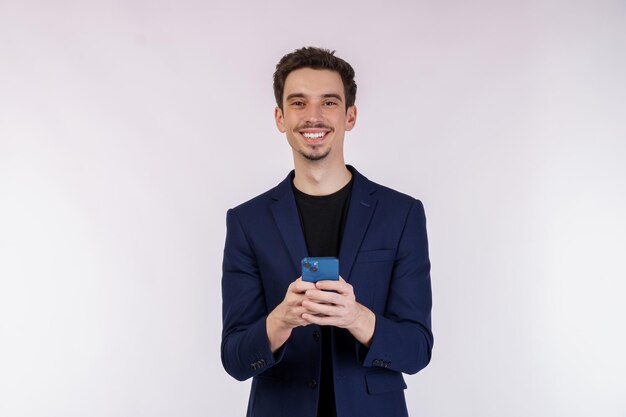 Portrait of a happy businessman using smartphone over white background