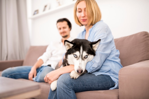 Free Photo portrait of happy couple at home with dog