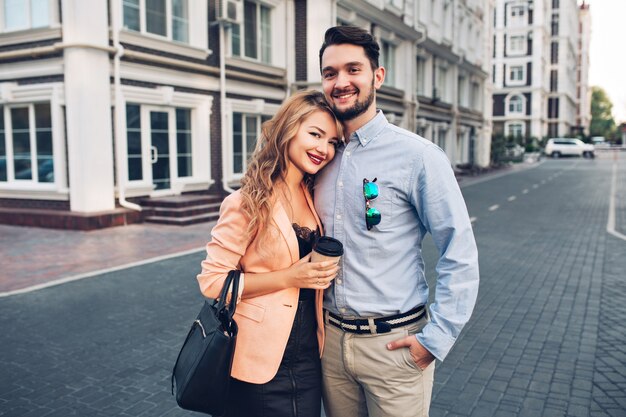 Portrait happy  couple hugging in British quarter.