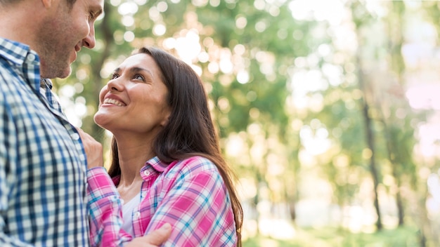 Portrait of happy cute lovers embracing at park