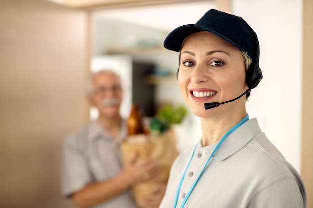 Portrait of happy delivery woman looking at camera