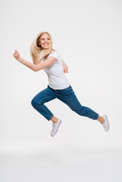 Free photo portrait of a happy excited woman jumping