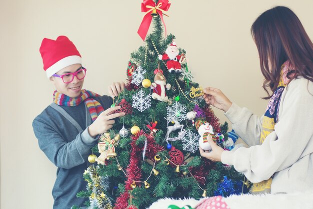 Portrait of happy family decorating Christmas tree