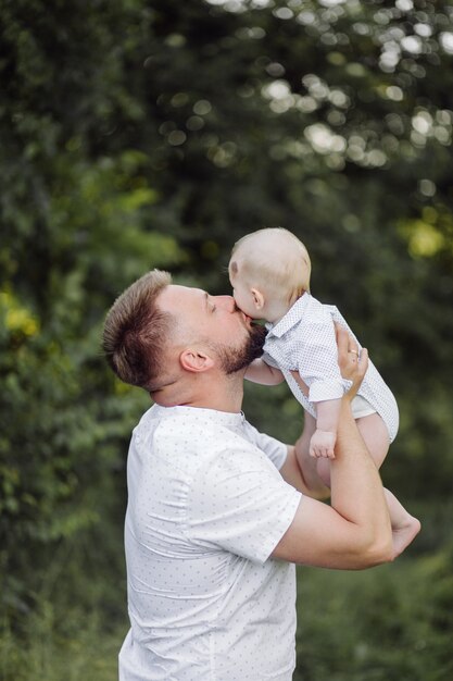 Portrait of Happy family at sunset spending time and playing in nature.