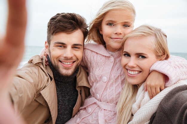 Portrait of a happy family with a little daughter